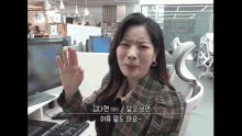 a woman sitting at a desk with a dell computer