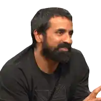 a man with a beard is wearing a black shirt with a union jack on the front
