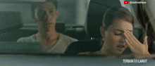 a man and a woman are sitting in a car with astroshaw written in the corner