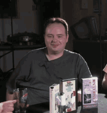 a man is sitting at a table with a box that says internet family