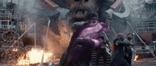 a man in a purple glove is being held by another man in a black coat