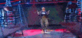 a man is riding a horse on a stage giving the peace sign