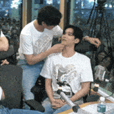 a man wearing a shirt that says ' comilly ' on it
