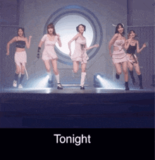 a group of young women are dancing on a stage and the word tonight is below them
