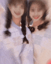two girls are posing for a picture together and smiling .