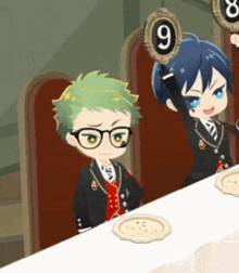 a boy and a girl are sitting at a table with plates and a number 9 on it .