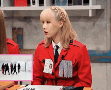a woman in a red jacket with a name tag that says ' nm ' on it