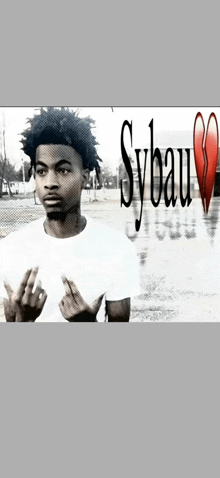 a young man in a white shirt is standing in front of a sign that says sybaum