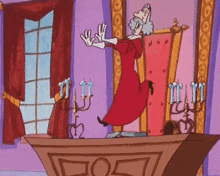 a cartoon character in a red dress is standing on a table with candles on it .