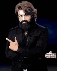 a man with a beard and long hair is wearing a black suit by prashant gangwani