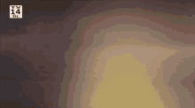 a blurred image of a tv 14 logo on a dark background .