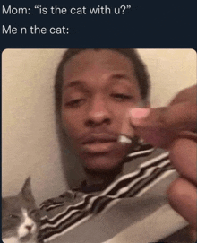 a man is holding a cat in front of his face with a caption that says " mom : is the cat with u "