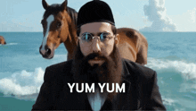 a man with a beard and glasses stands in front of a horse with the words yum yum written below him