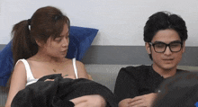 a man and a woman sitting next to each other on a couch