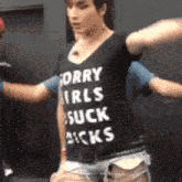 a woman wearing a black t-shirt that says sorry girls suck sucks