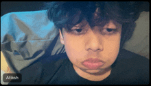 a person laying on a bed with the name atiksh on the bottom