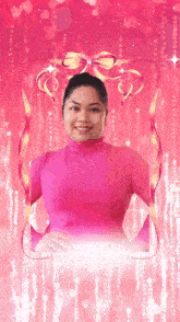a woman in a pink turtleneck is surrounded by ribbons on a pink background