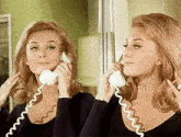 a woman is talking on a phone in front of a mirror