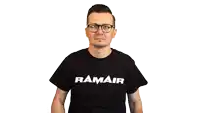 a man wearing glasses and a black pamair t-shirt