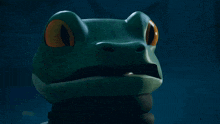 a close up of a frog with orange eyes