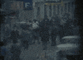 a crowd of people walking down a street in front of a banyo sign