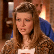 a woman wearing a leopard print jacket and a white t-shirt