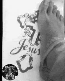 a black and white photo of a person 's feet with a picture of jesus
