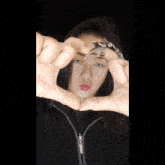 a woman wearing a black jacket with a zipper that says edc
