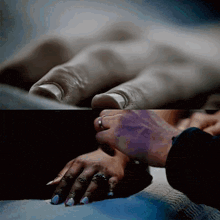 a close up of a person 's hand with a ring on their finger