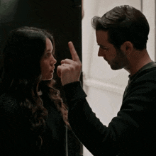 a man and a woman are looking at each other in a doorway