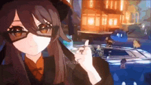 a girl wearing glasses and a hat is giving a thumbs up .