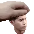 a hand is holding a man 's head in a pixel art .