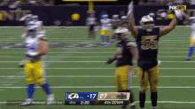 a football player with the number 55 on his jersey stands on the field