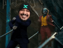 a man with a x on his hat is standing next to a clown