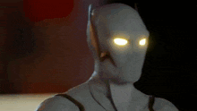 a close up of a superhero with yellow eyes