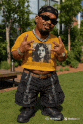 a man wearing a yellow crop top with a picture of a woman on it