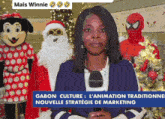 a woman stands in front of a sign that says mais winnie