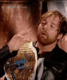 a man with a beard is wearing a world heavyweight wrestling championship belt .