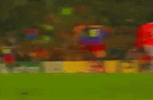 a blurry picture of a soccer game with a sign that says novor on it