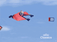 an advertisement for sesame street classics shows a man in a cape flying through the air