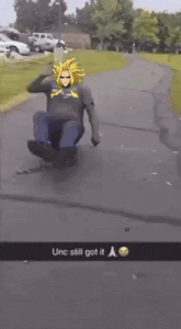 a man is sliding down a sidewalk with a cartoon character on his shirt .