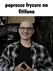 a man wearing glasses and a plaid shirt is smiling in a meme