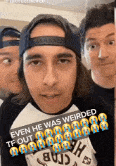 a man wearing a baseball cap and a shirt that says " even he was weirded " looks at the camera