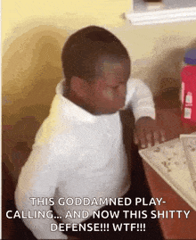 a young boy is sitting at a desk with his eyes closed and the words this goddamned play