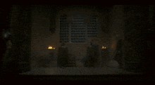 a group of men are standing in a dark room with a window