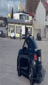 a black car is parked in front of a building with a sign that says domino 's