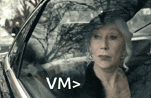 a woman in a car with the word vm above her head