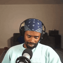 a man wearing headphones and a blue bandana with the word country on it