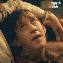 a close up of a man 's face with the words " you 're my hero " on the bottom right