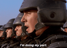a man in a helmet says " i 'm doing my part " in front of a row of soldiers